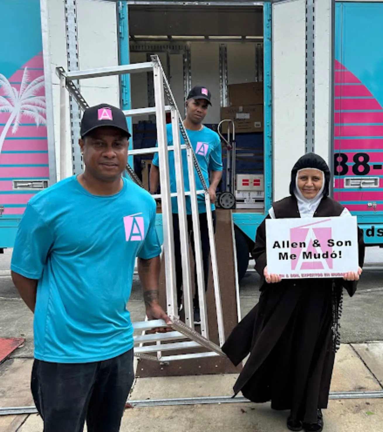 Allen & Son mover in company shirt and cap with a customer holding an Allen & Son Me Mudo sign beside the truck