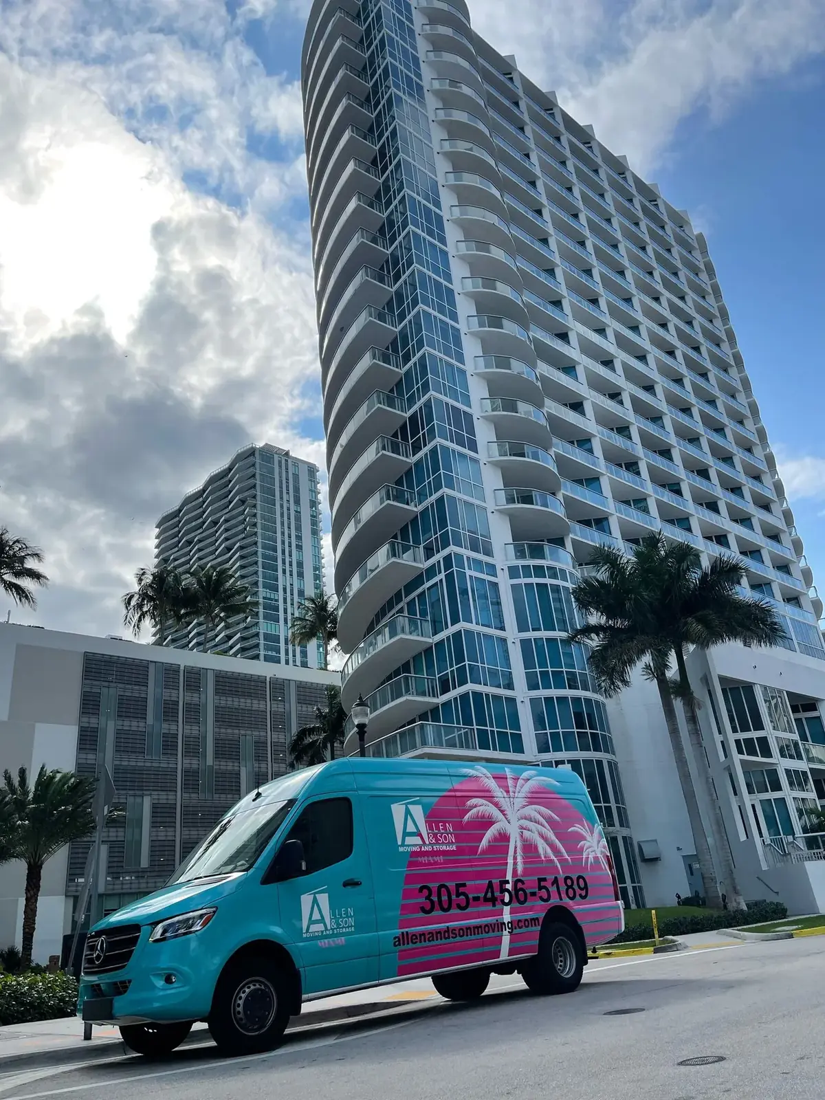 Allen & Son Moving branded van parked in front of a Miami high-rise
